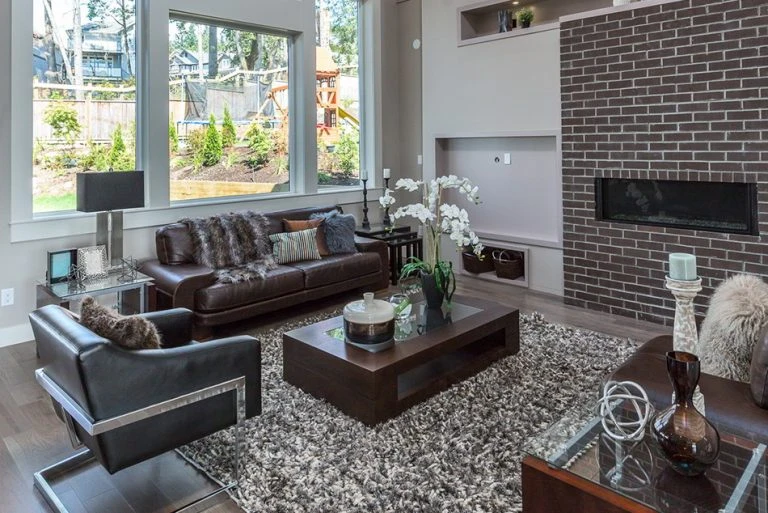 Explore the modern living room interior of Aura Phase 1, custom homes by Noura Homes