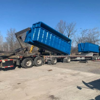 Dumpster rental service truck of Bill Kline Acres with roll-off container