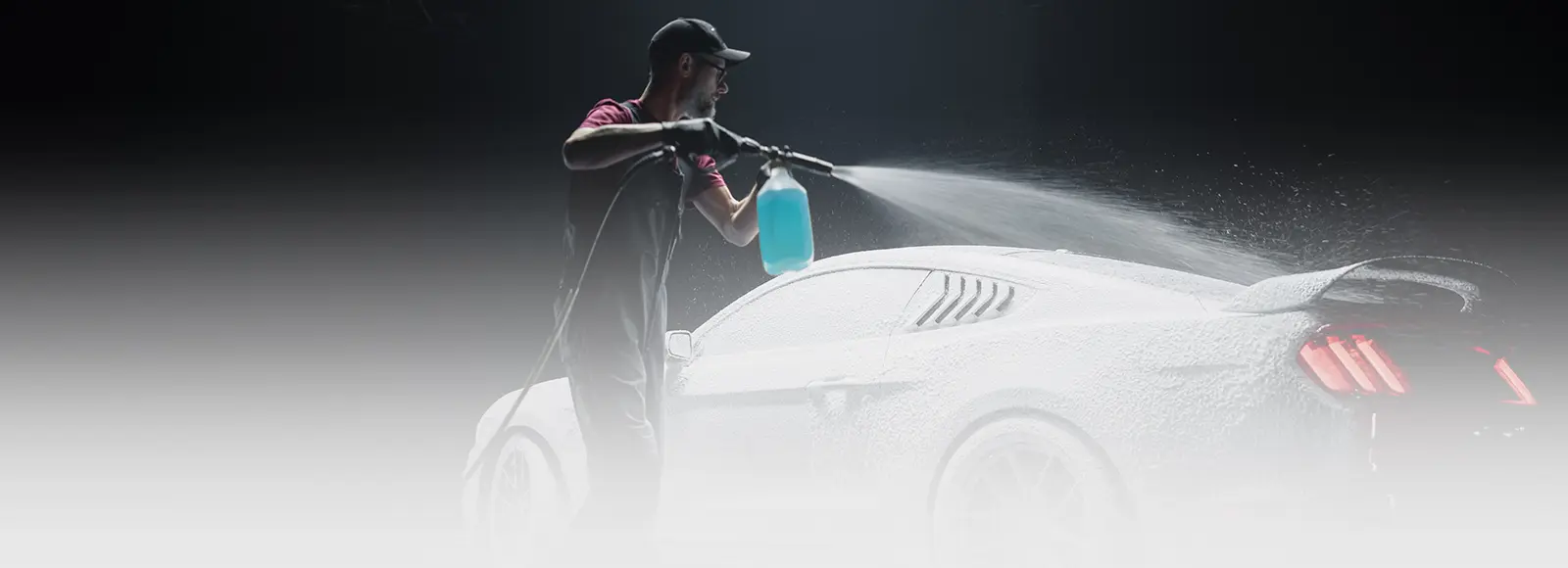 Technician performing Hand Car Wash in Toronto on red car