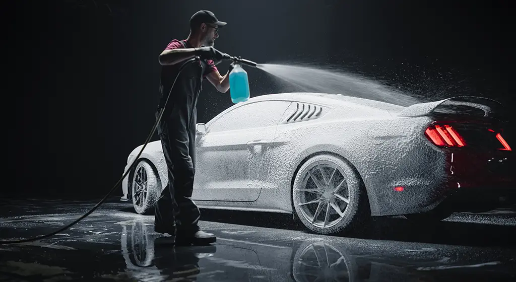 Technician performing Hand Car Wash in Toronto on red car