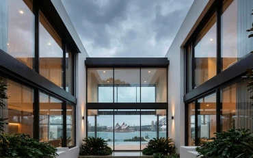 Interior living space illuminated by natural light through glazing installed using luxury window system services in Sydney. and Belgium and Belgium