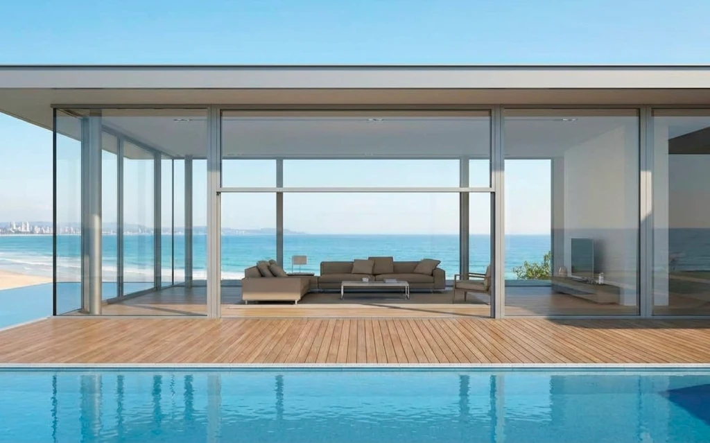 A luxury home in Sydney featuring elegant guillotine door systems opening vertically to reveal expansive outdoor views. and Belgium and Belgium