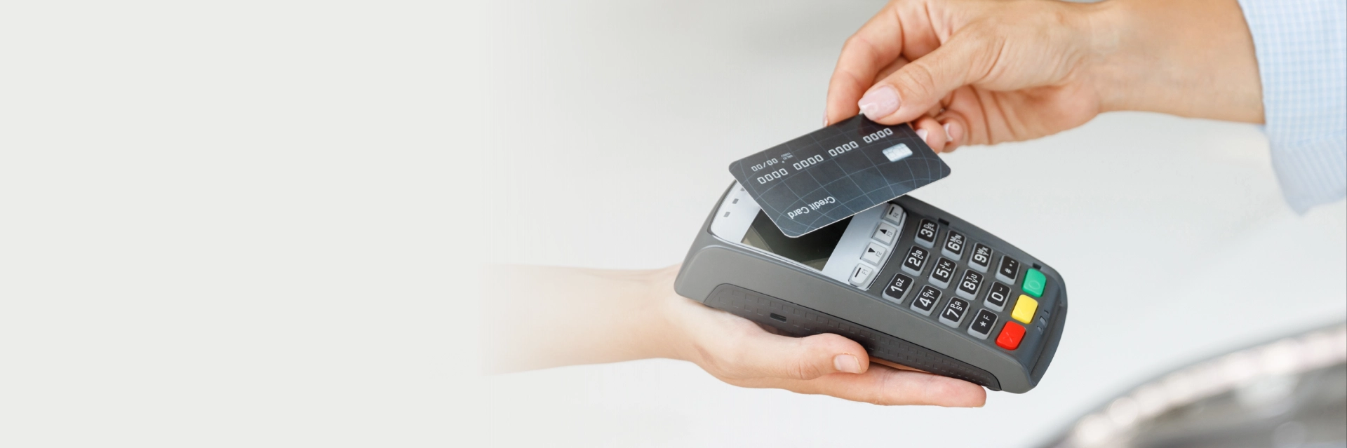 Small business owner completing a customer credit card transaction at checkout