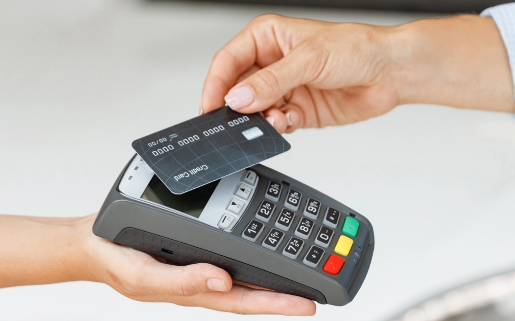 Small business owner completing a customer credit card transaction at checkout