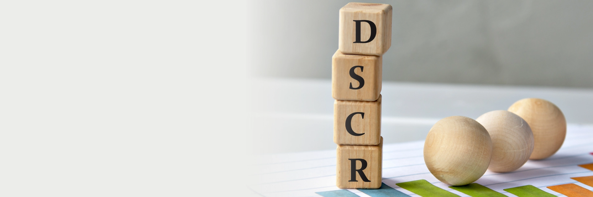 Real estate investor reviewing property documents with financial projections on screen