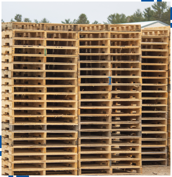 Worker inspecting newly built pallets