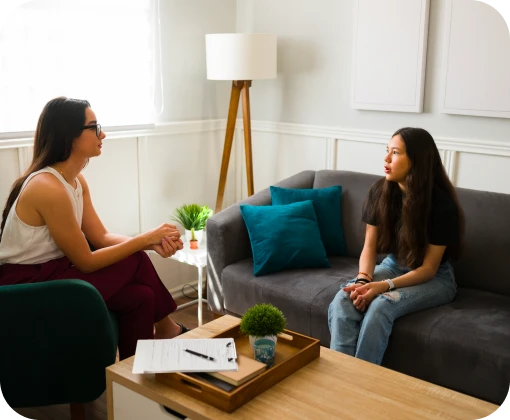 A counselor smiles warmly during a one-on-one appointment for mental health counseling and therapy services in Williamsburg.