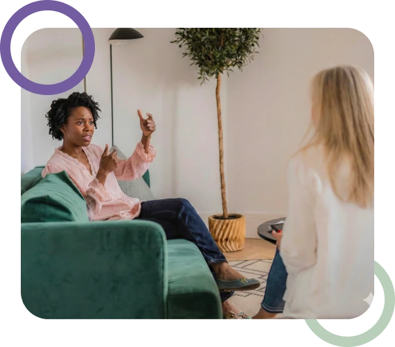 A client speaking openly with their therapist during individual psychotherapy services.