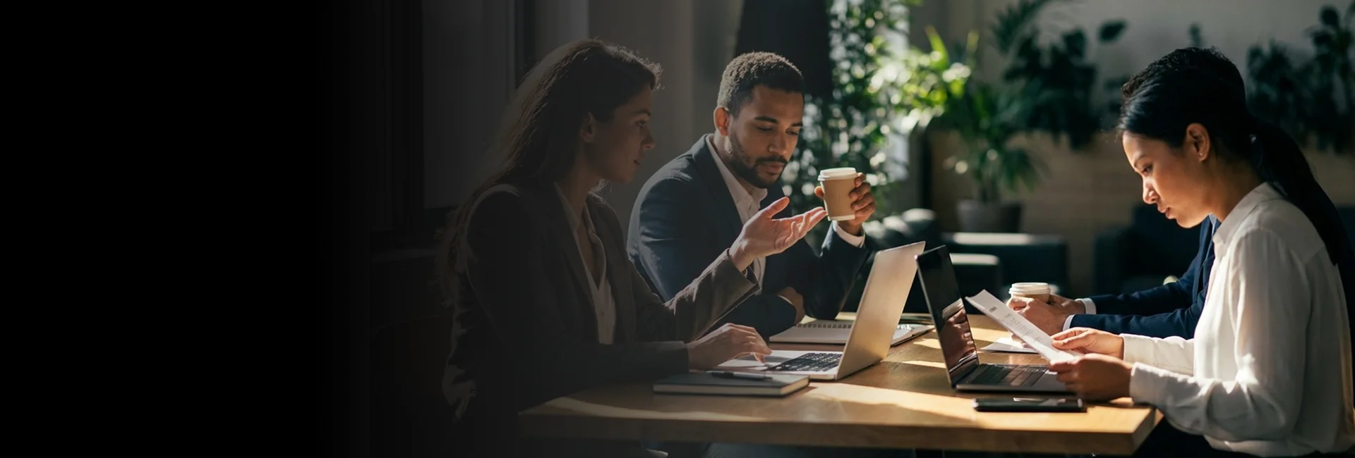 A former student-athlete reviews potential career opportunities while working at a modern desk.