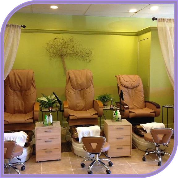 Owner consulting client at a nail salon in West Hartford, CT
