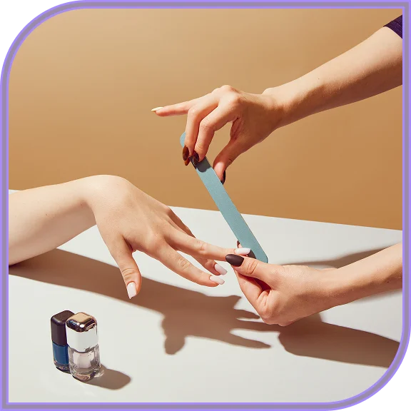 Client receiving gel manicure services in West Hartford
