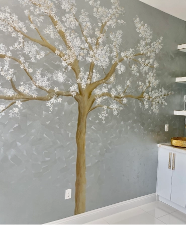 Designer installing artwork as part of interior decorating services in Bakersfield.