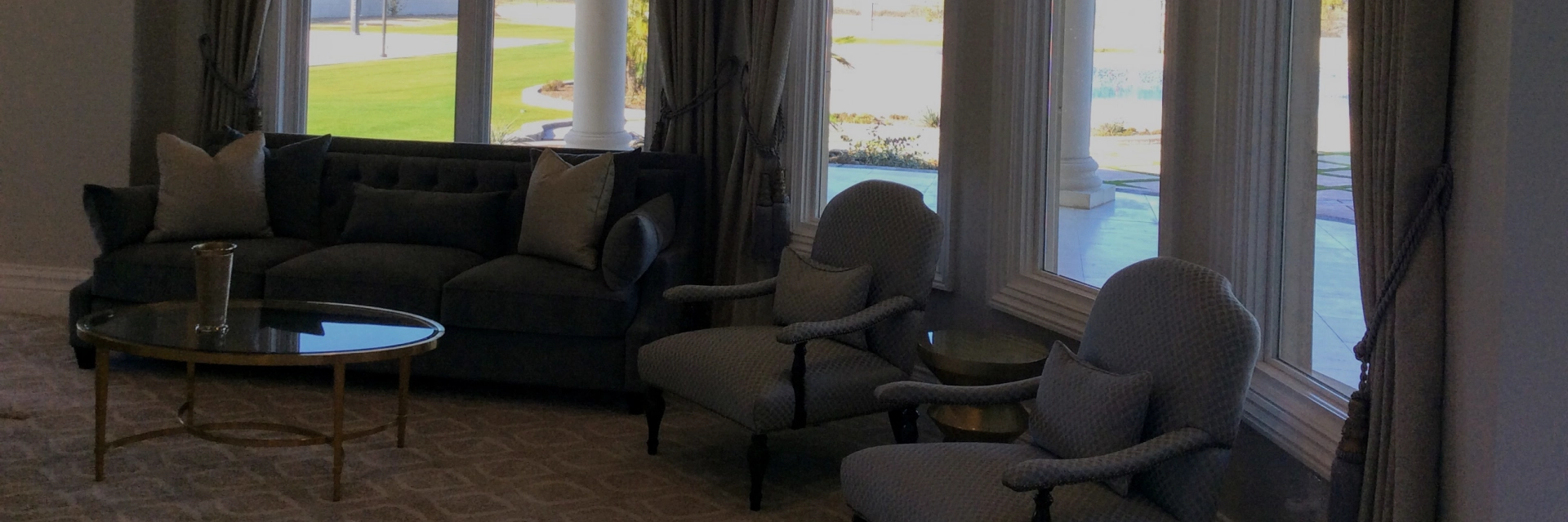 Interior decorator in Bakersfield measuring a living room for updates.