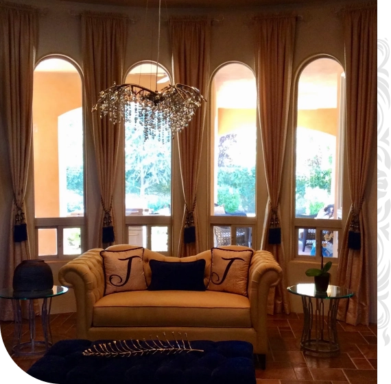 Designer adjusting curtains during custom window coverings installation in Bakersfield.