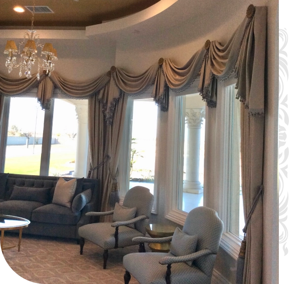 Designer installing custom draperies services in Bakersfield in a luxury living room.