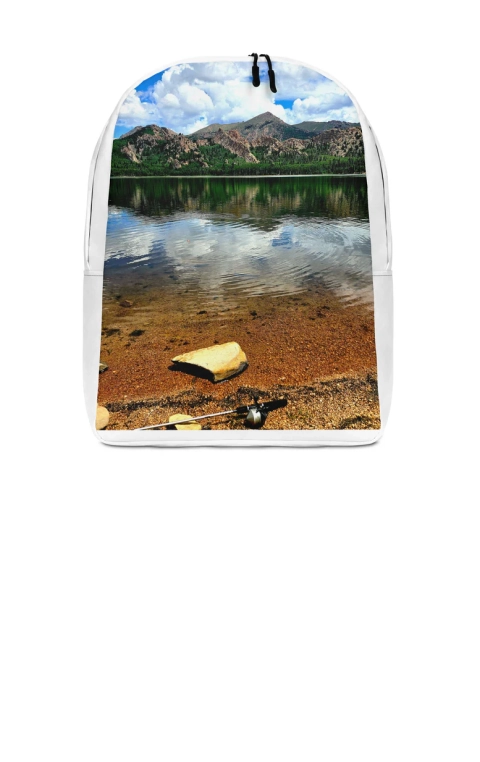 Traveler adjusting the handle of a suitcase with detailed photo printing on luggage.
