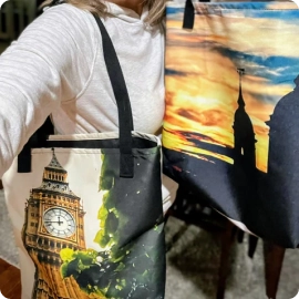 A backpack with bright photo printing on luggage being packed for a trip.