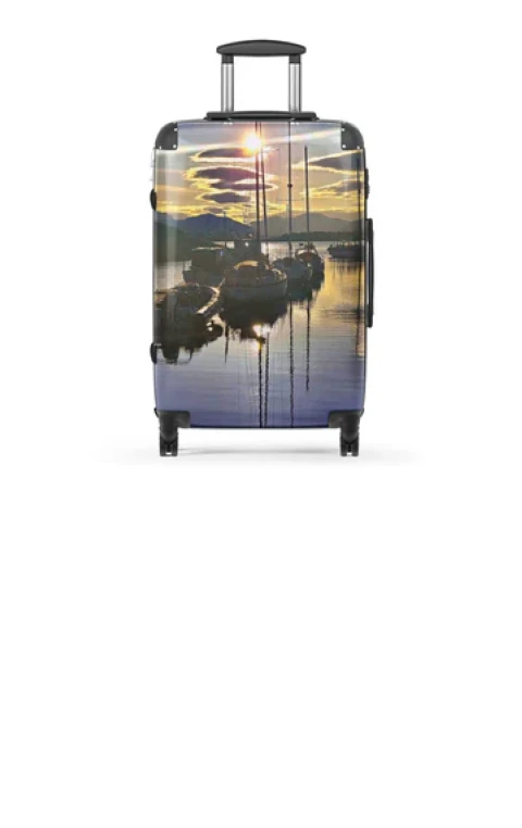 Traveler checking luggage tag while using a suitcase with photo printing on luggage.