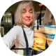 Traveler checking luggage tag while using a suitcase with photo printing on luggage.