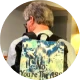 Traveler checking luggage tag while using a suitcase with photo printing on luggage.