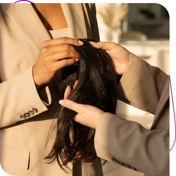 A stylist adjusts placement during a private fitting for hair toppers for thinning hair in St. John’s.