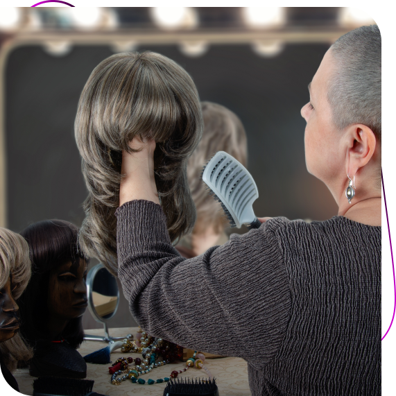 A stylist adjusts a client’s fit during a private consultation for wigs for hair loss in St. John’s.