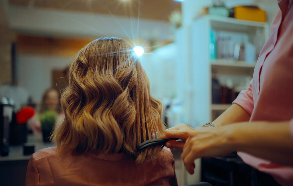A stylist applies balayage services in Vero Beach to a client’s hair.

