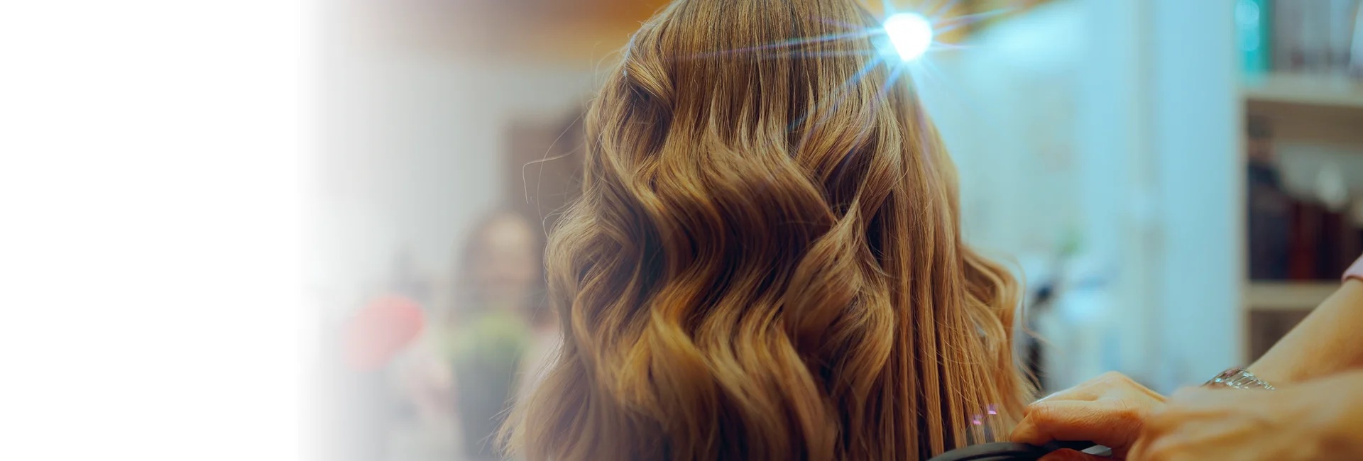A stylist applies balayage services in Vero Beach to a client’s hair.
