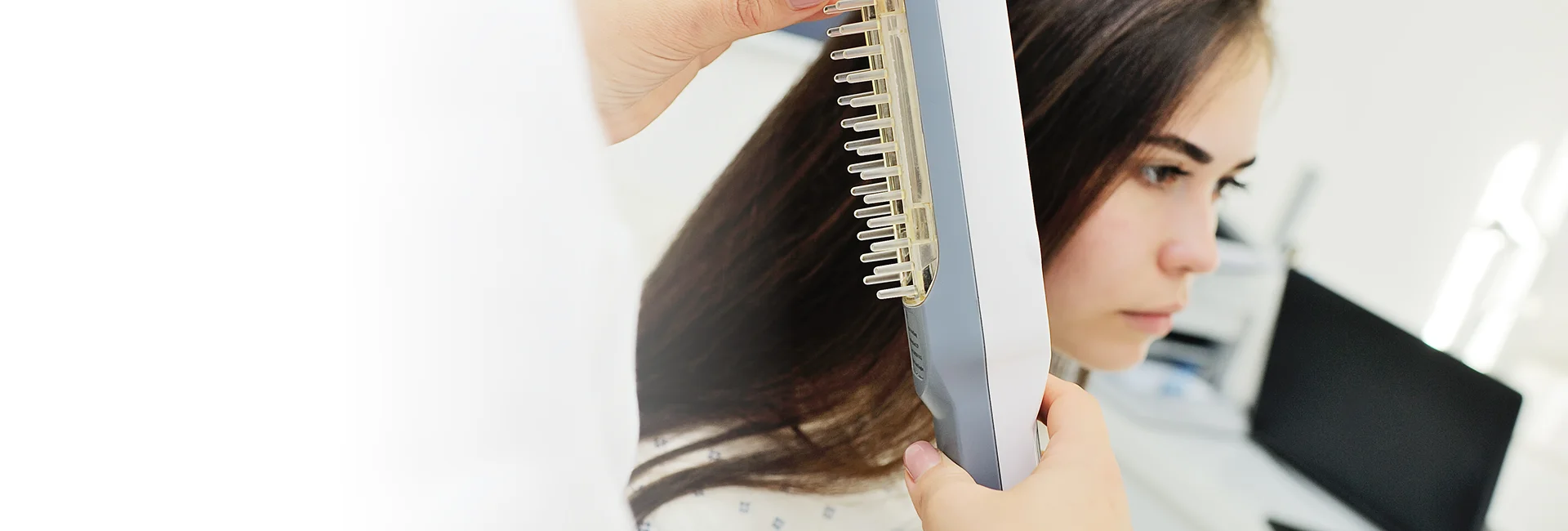 A stylist fits hair toppers in Vero Beach for a client.


