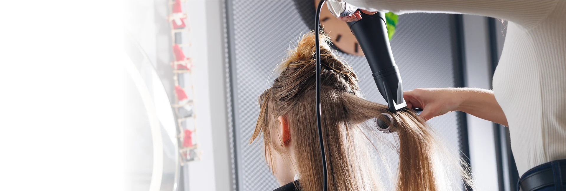 A stylist performs hair styling in Vero Beach on a client.



