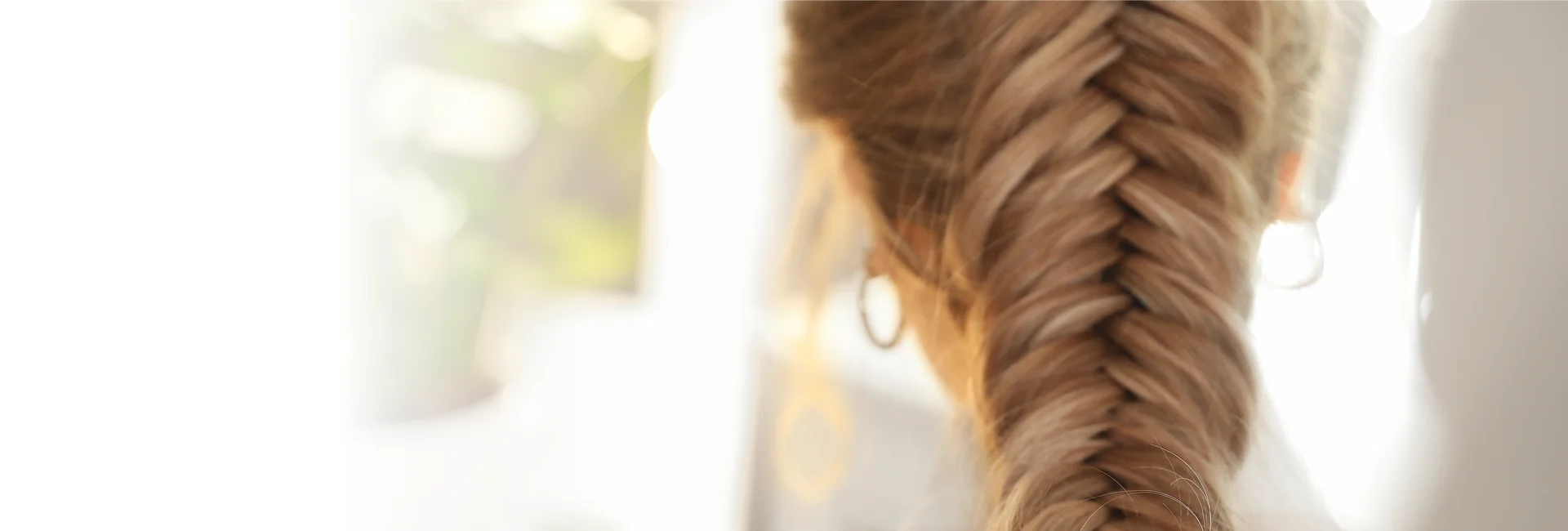 A stylist creates braiding services in Vero Beach on a client.


