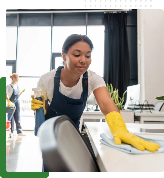 Staff member completing commercial cleaning services in a large corporate workspace.