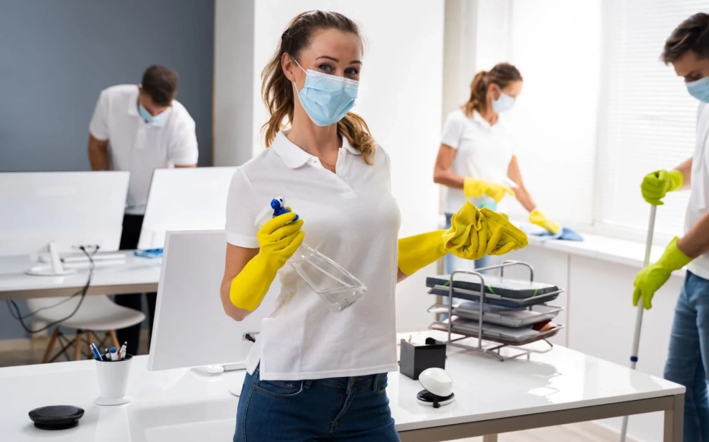 Technician performing disinfection services in Edmonton inside a corporate office.