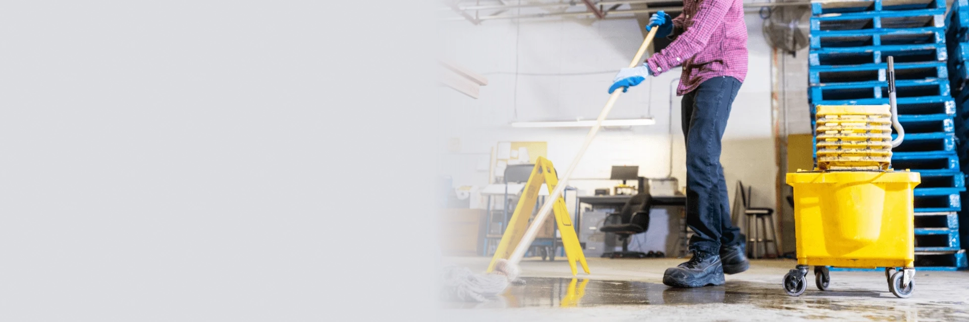 Industrial team performing garage cleaning services in Edmonton inside a commercial vehicle bay.