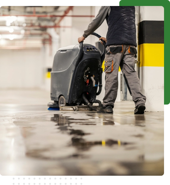 Industrial sweeper operating during underground parkade cleaning services in Edmonton.