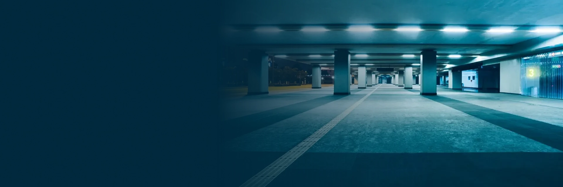 Cleaning crew performing underground parkade cleaning services in Edmonton inside a residential parking structure.