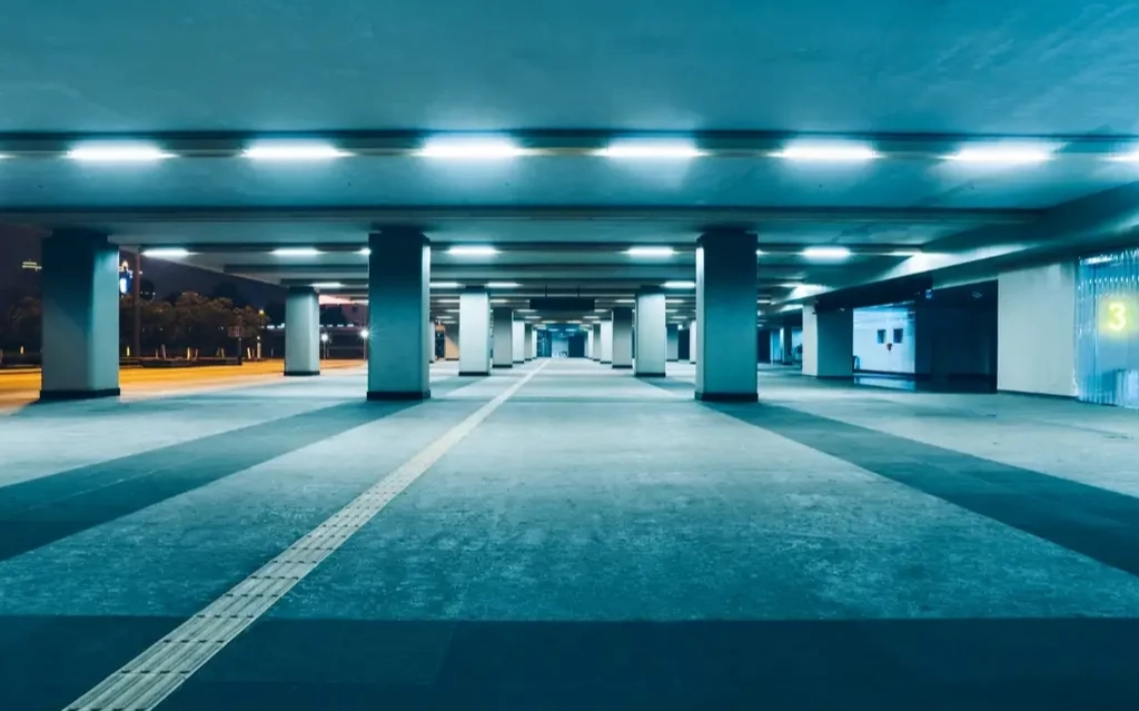 Cleaning crew performing underground parkade cleaning services in Edmonton inside a residential parking structure.