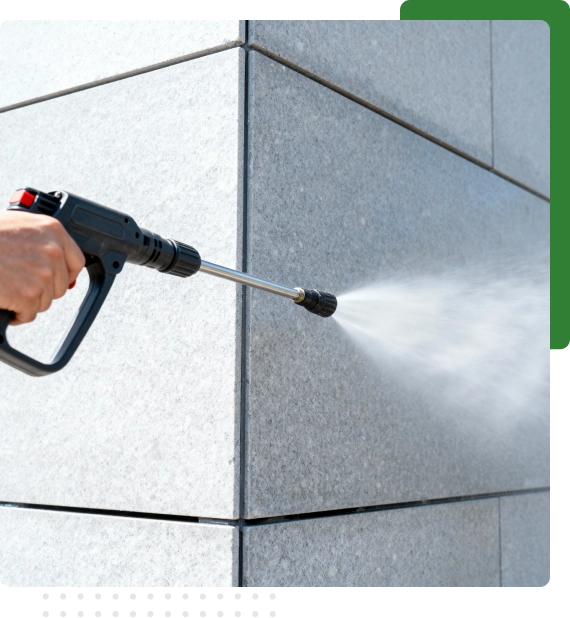 Crew removing mold buildup with building pressure washing services in Edmonton.