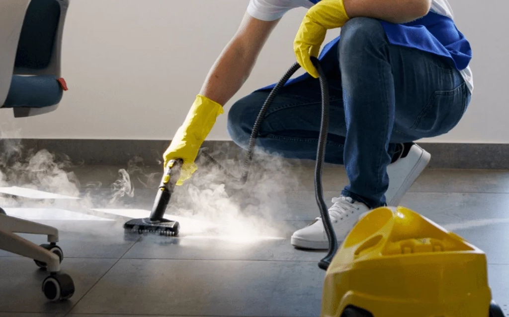 Technician performing floor strip services in Edmonton inside a commercial building.