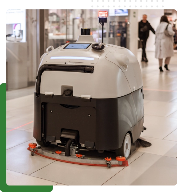 Technician working from scissor lifts to clean overhead fixtures.