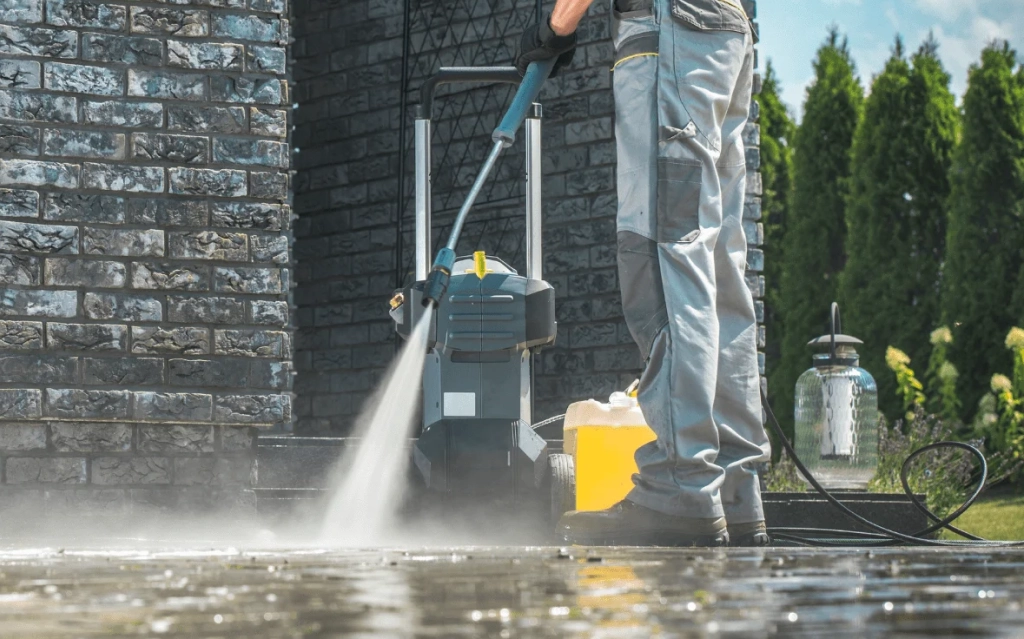 Operator using ride-on machines to clean a large commercial floor.