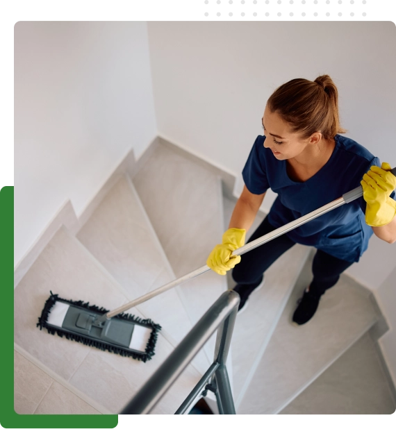Technicians using industrial equipment to clean a warehouse floor safely and efficiently.