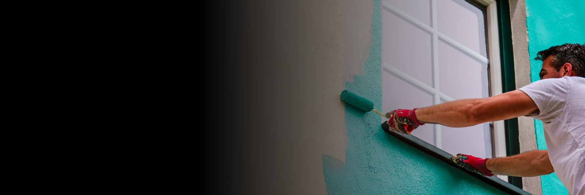 Exterior painting Calgary specialists refreshing a stucco and brick residential facade.