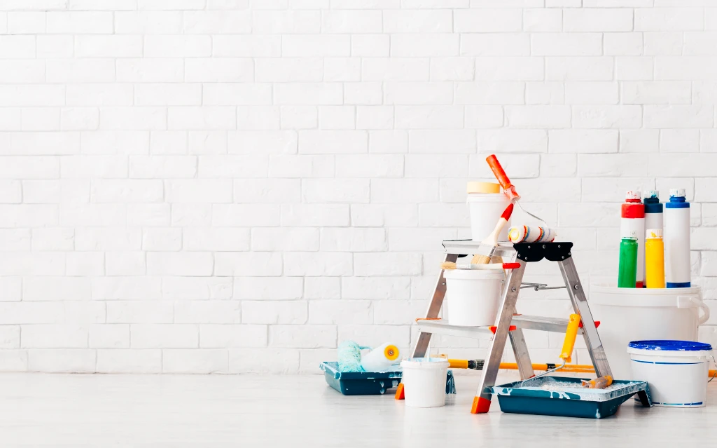 Exterior painting Calgary specialists refreshing a stucco and brick residential facade.