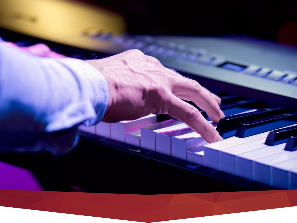 A grand piano set on stage during live piano and keyboard performances in a New York concert hall.