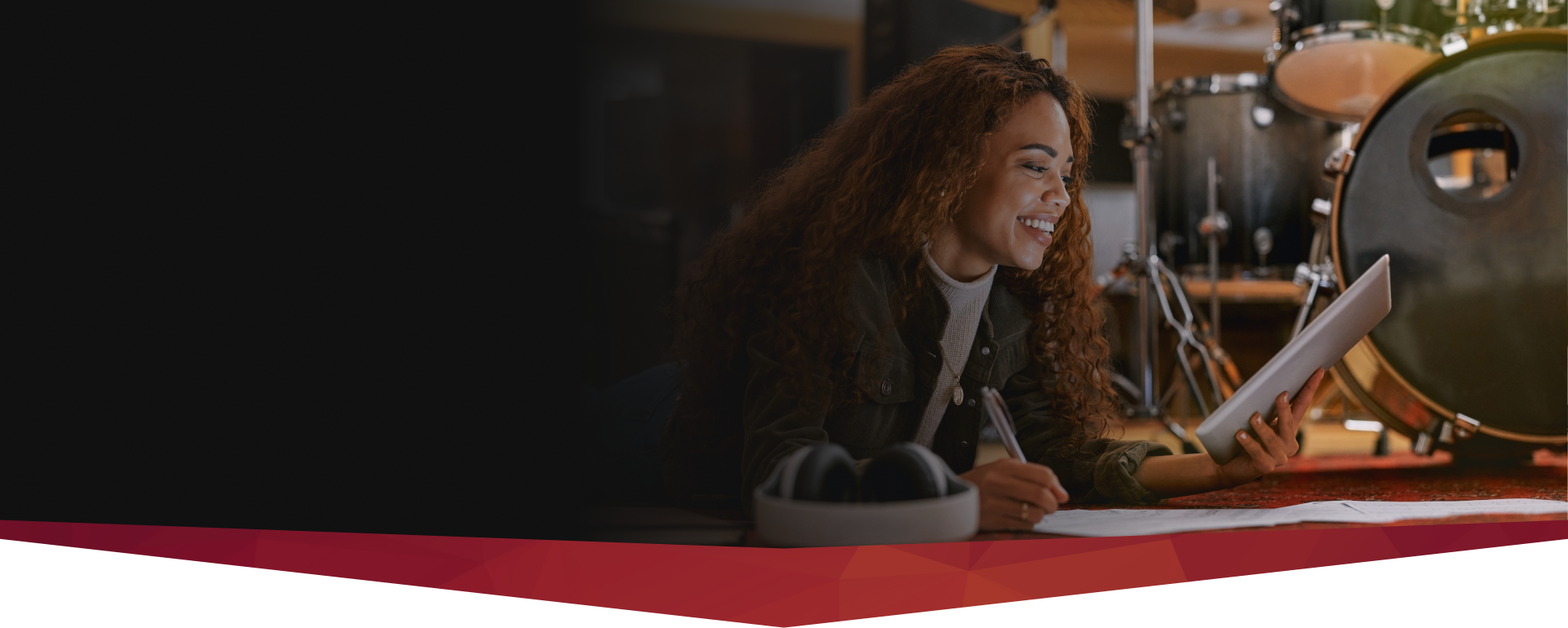 A mentor leading interactive songwriting courses and workshops in a professional studio setting.