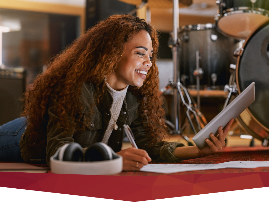 A mentor leading interactive songwriting courses and workshops in a professional studio setting.