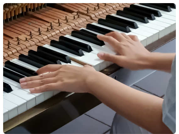 A small group workshop inside a music education school in  focused on songwriting technique.