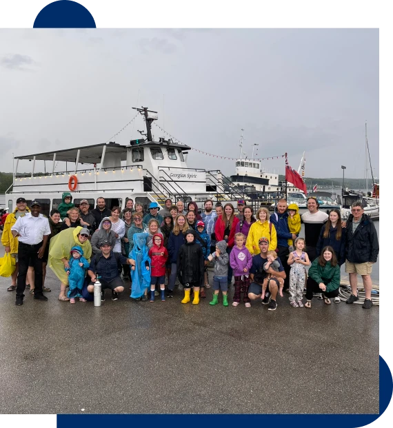A group boarding a vessel at the marina for boat tours along the shoreline of Georgian Bay.