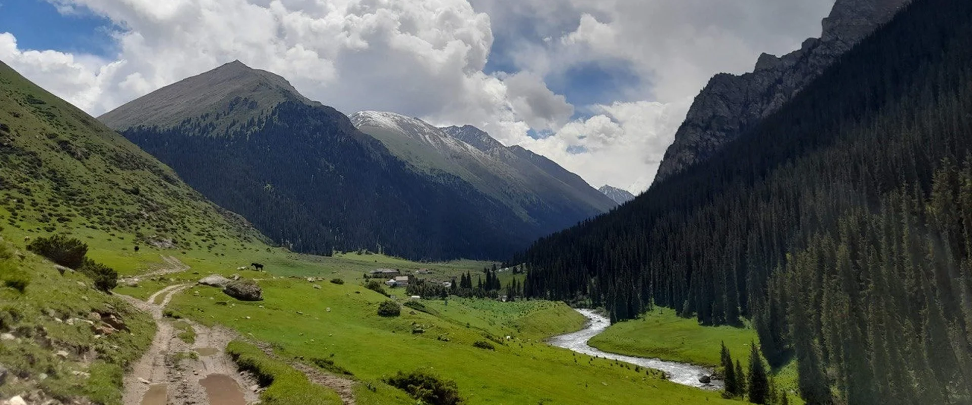 Travel experts guiding travelers through alpine valleys in Kyrgyzstan